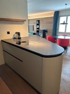 a kitchen with a island with a counter top at Casa Partnun 4-3 in Laax-Murschetg