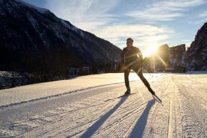 a man is skiing down a snow covered slope at Casa Partnun 2-9 in Laax-Murschetg
