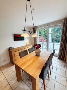 ein Esszimmer mit einem Holztisch und Stühlen in der Unterkunft Ferienhaus Pauline in Glücksburg + 40 Fotos