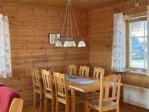 a dining room with a wooden table and chairs at Nobel Cabins - Tänndalen in Tänndalen
