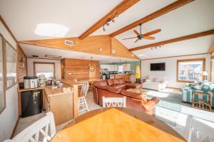 a living room with a couch and a table at Genesis On The Water, Views! Views! Views! in Rodanthe