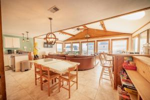 a kitchen and living room with a table and chairs at Genesis On The Water, Views! Views! Views! in Rodanthe +15 photos