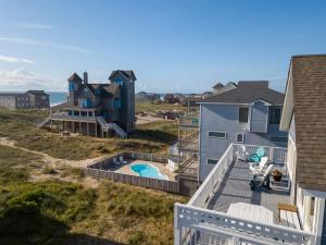 a balcony with a view of a house and a pool at Genesis On The Water, Views! Views! Views! in Rodanthe