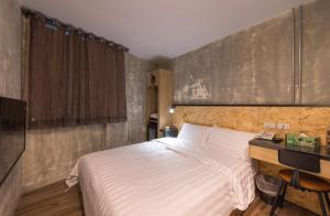 Postel nebo postele na pokoji v ubytování Beimen WOW Poshtel
