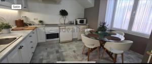 a kitchen with a table and chairs in a room at La Perla De La Bahía, Espectacular in Bahia de Casares