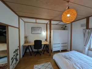 a bedroom with a bed and a desk at Migiwa House in Rankoshi +22 photos