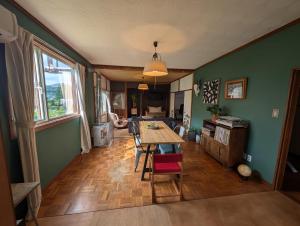 a kitchen and dining room with a table and chairs at Migiwa House in Rankoshi