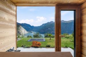 a room with a view of a lake and mountains at Lingåsen Panorama! in Valldal
