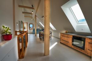 a kitchen and dining room with a skylight at House Elipsa in Bovec