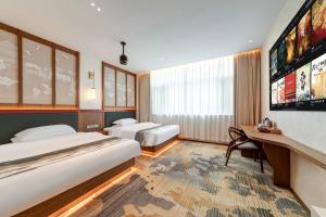 a hotel room with two beds and a tv at Floral Hotel Yinshiyi Chang'an, Xi'an Bell and Drum Tower Sajinqiao Subway Station in Xi'an