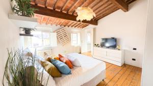 a bedroom with a bed with pillows and a tv at Residenza Sky View Roofview free parking in Verona
