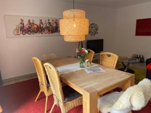 a dining room with a wooden table and chairs at Ferienwohnung Lenzen in Kall
