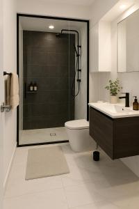 a bathroom with a shower and a toilet and a sink at FREE Parking Modern 2 bedrooms Apt for Family or Business in Sydney