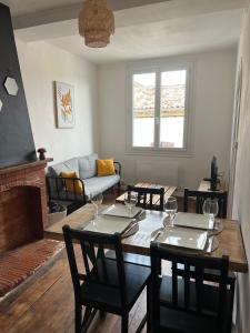 a living room with a table and chairs and a couch at Cocon au cœur du centre ville de Bazas in Bazas