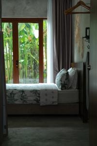 a bed in a room with a large window at Chrisenbel Hideaway Retreat in Petaling Jaya