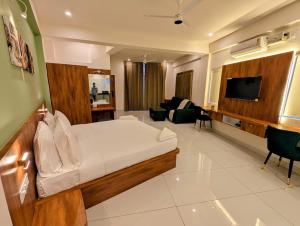 a bedroom with a bed and a living room at Sihi Homes in Mysore