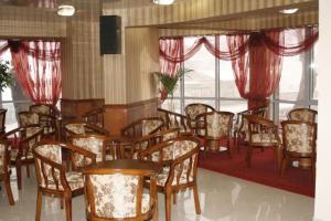 a group of chairs and tables in a room with windows at Hotel Elegance in Asenovgrad +28 photos