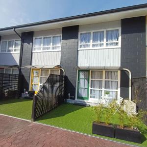a house with a green lawn in front of it at City Central in Nelson