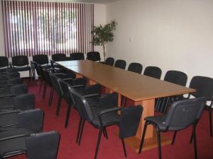 a conference room with a large wooden table and chairs at Hotel Elegance in Asenovgrad