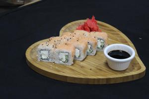 a wooden plate with sushi and a bowl of sauce at Turkistan in Türkistan +28 photos
