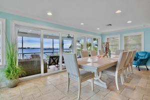 a dining room with a table and views of the ocean at The Bayfront in Bradenton Beach
