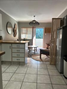a kitchen with a table and a bench in it at Lang Apartment in Great Brak River