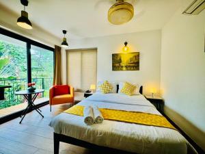 a bedroom with a large bed and a balcony at HALF Hotel, Calangute in Calangute