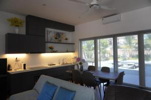 a kitchen and dining room with a table and chairs at KevilHome - Mini villa có hồ bơi in Da Nang