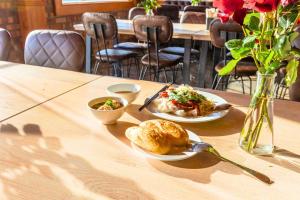 a table with two plates of food and a bowl of soup at Moon Garden Hotel in Da Lat