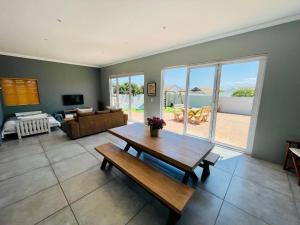 a living room with a table and a couch at The Kite Cottage in Langebaan