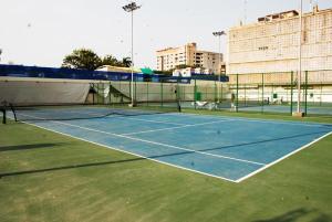 a tennis court with a tennis racket on it at Hotel BlueSky Clifton 2 in Dargai