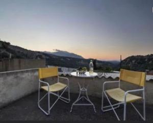 two chairs and a table on a balcony at Moundros 1620 Venetian Residence in Moúndros