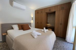 a bedroom with two beds with towels on them at Renovated House In The Center Of Beausoleil in Beausoleil