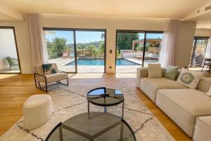 a living room with a couch and a table at Villa A Calia di Fiori Mare in Sainte-Lucie de Porto-Vecchio