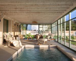 a house with a pool in the middle of a living room at Wishome-Preciosa villa recién reformada con piscina climatizada in Caviedes