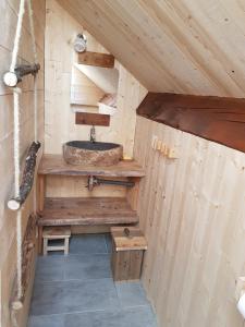 a bathroom with a sink in a wooden house at Gîte Le Lac à La Dame in Foncine-le-Bas