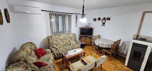 a living room with a couch and a table at Drijenak Nature Escape in Kolašin