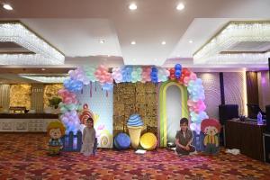 a birthday party with balloons and children in front of a backdrop at The Hotel Sundaram Continental in Prayagraj