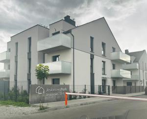 a white building with a tree in front of it at Apartament Camila in Leszno