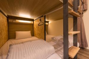 a bedroom with two bunk beds in a room at Beimen WOW Poshtel in Taipei
