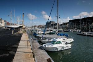 a group of boats are docked in a harbor at T2 Nid Serein, jardin, calme, proche centre-ville, port, plages in Courseulles-sur-Mer