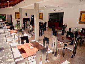 a restaurant with tables and chairs in a room at Tissa Wild Heaven in Tissamaharama