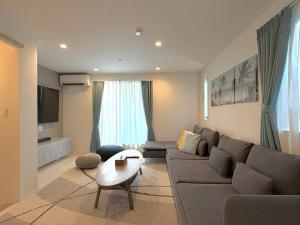 a living room with a couch and a table at Casa Stella 1 Aquarius by Liaison in Osaka