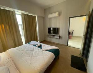 a bedroom with a large bed and a large mirror at Ayush residency in Varanasi