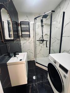 un bagno con doccia, lavandino e WC di Apartament a Tarnowskie Góry