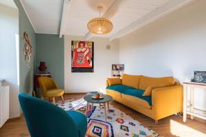 a living room with a couch and two chairs at La Casita in Beauvène