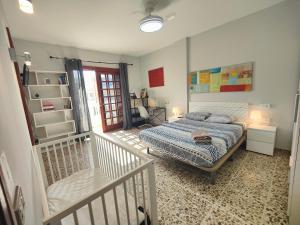 a bedroom with a bed and a chair in it at Amplia casa 5 habitaciones en Santa Cruz con zona para trabajar in Santa Cruz de Tenerife +72 photos