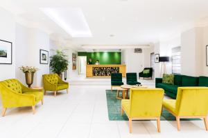a living room with yellow and green furniture at Tranquil Haven in Cape Town