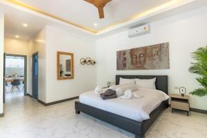 a bedroom with a large bed with white sheets at villa Akala in Ban Saiyuan (1) +31 photos