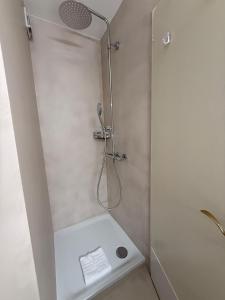 a shower with a shower head in a bathroom at Jäggi 35 by Arosa Holiday in Arosa +7 photos